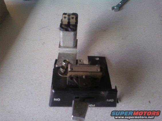 automotive electrical relay and switch assembly with 'ON' and 'OFF' labels