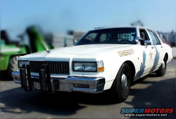 White sheriff car with push bumper and 'SHERIFF' text on door