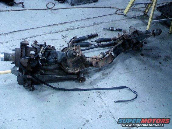0207091157.jpg front axle out of the truck. I replaced the radius arm bushings amd pivot bushings with urethane ones before reinstalling it.