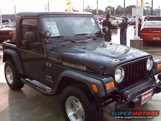 Black Jeep Wrangler with "Wrangler" badging on fender
