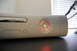 2002 BMW M3 - Close-up of an Xbox 360 console, showing the power button with red ring error indicators.