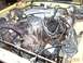 1982 Ford Mustang - The engine bay of a car is shown, filled with various mechanical parts and wiring.