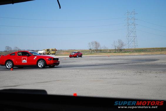 Red Ford Mustang with Marlboro livery on track, number 2 visible. 2005 model