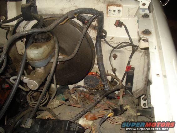 Engine bay wiring harness and brake booster assembly
