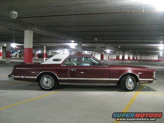 Maroon Lincoln Continental Mark V parked in a garage