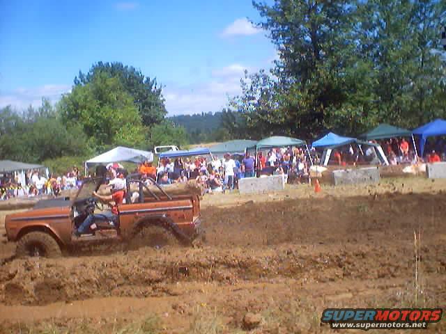 Orange 1976 Ford F-100 Bronco in mud pit