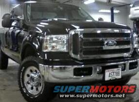 Black Ford F-Series truck, front view, in a garage