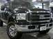 1994 Ford F-250 - This black Ford truck is parked inside a garage with its front end facing the camera.