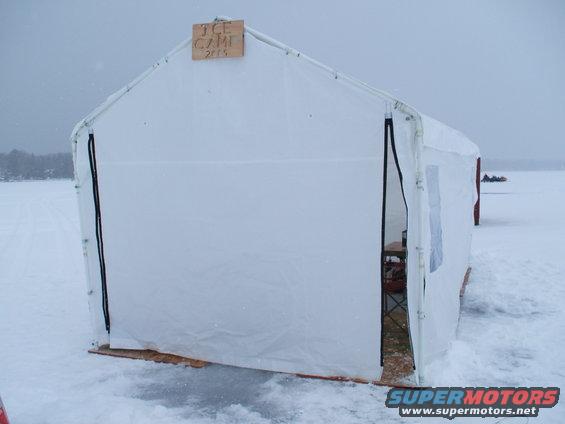 White tent labeled ICE CAMP 2015 on frozen surface
