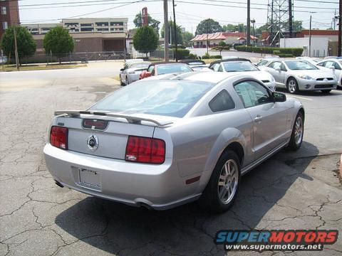 Silver 2005 Ford Mustang coupe parked outside with other cars in the background