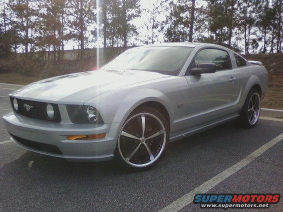 Silver 2005 Ford Mustang parked outside with trees in the background
