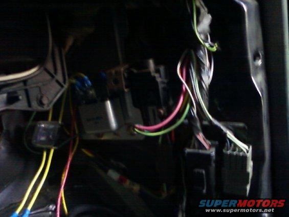 Close-up of vehicle wiring and electrical components, possibly under the dashboard