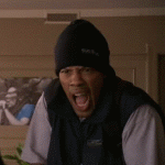 Man in beanie and vest yelling