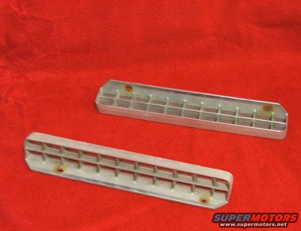 Two aluminum vent grilles with a grid pattern, shown on a red background