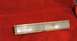 1989 Ford Bronco II - Clear plastic marker light assembly, likely for a vehicle, rests on a red textured surface.