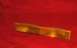 1989 Ford Bronco II - Amber turn signal lens with textured surface is shown against a red background.
