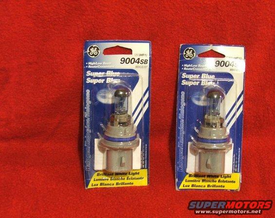 Two GE 9004SB Super Blue halogen headlight bulbs in blue and white packaging on a red background