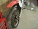 2005 Honda CR125R - Rear view of a dirt bike, showing the knobby tire and red fender, with a red Craftsman tool chest to the left.