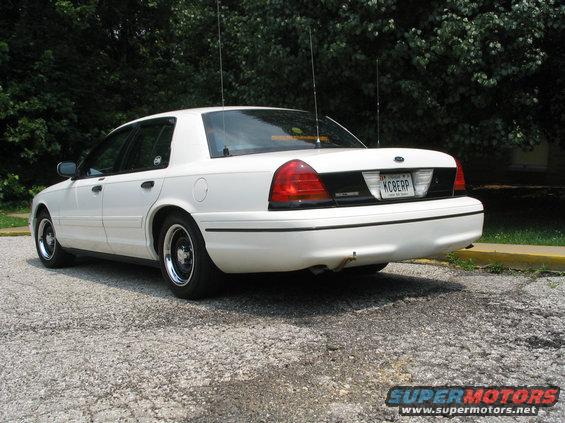 White 1998 Ford Crown Victoria, rear view with license plate KCBERP