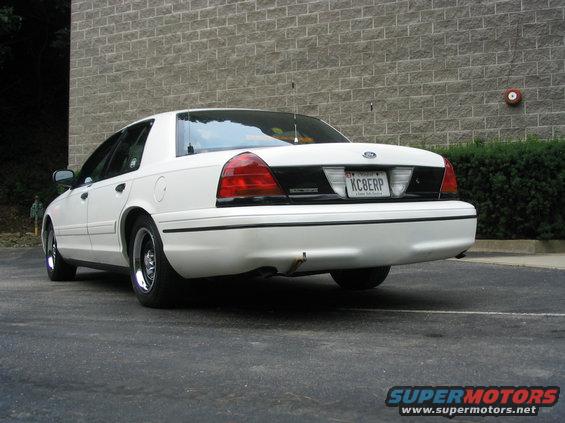 Rear view of a white 1998 Ford Crown Victoria parked on asphalt. License plate KCBERP