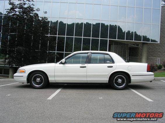 White 1998 Ford Crown Victoria sedan parked in a lot, side view