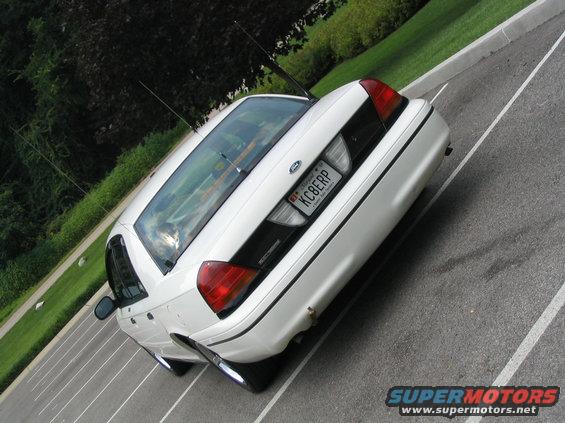 Rear view of a white 1998 Ford Crown Victoria with a KC8ERP license plate