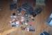 2004 Arctic Cat F-7 Firecat - Various remote control car parts and partially assembled vehicles are spread out on a wooden floor.