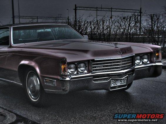 Front view of a maroon 1971 Cadillac Eldorado with a chrome grille and quad headlights. License plate reads PBC 530