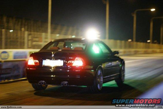 Black BMW M3 E46 rear view at night, dual exhaust pipes visible