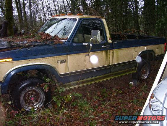 Side view of a blue and tan pickup truck, possibly from the 1980s
