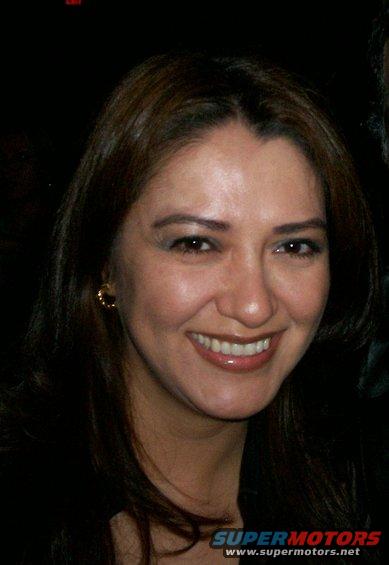 woman smiling, with a watermark at the bottom that says SUPERMOTORS