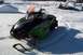 2004 Arctic Cat F-7 Firecat - A snowmobile sits in a snowy area with trucks in the background.