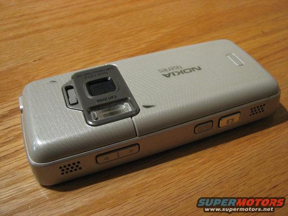 Nokia Nseries cell phone with Carl Zeiss lens on wooden surface