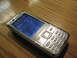 2003 Ford Crown Victoria - A silver Nokia mobile phone rests on a wooden table. The screen displays the time as 9:35 AM on February 20, 2009.