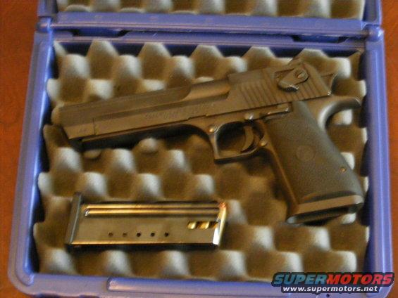 Pistol and magazine in a blue foam-lined case