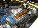 1978 Ford Ranchero - Close-up view of a V8 engine bay, a chrome air cleaner, orange valve covers, and blue spark plug wires.