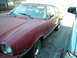 1975 Ford Mustang II - This 1975 Ford Mustang II coupe is seen from a 3/4 front angle, parked next to another vehicle.