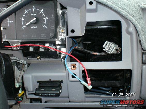 Remember this picture? You have the blue wire grounded to the rear window connector, thered wire (key only power)  to the red wire on the LED. I drilled a hole right next to my switch and popped the LED light in that. It has two wires on it,(red & black). They don't draw much but I like all my power to only run when the key is on but you can run it hot (always on) if you want.