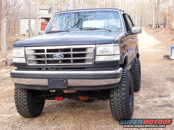 Dark blue 1992 Ford Bronco with lifted suspension and large tires, front 3/4 view