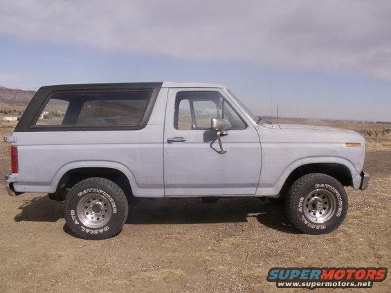 Light blue Ford Bronco, side view, showing its boxy body and removable hardtop