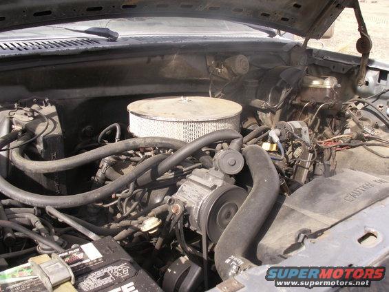 Engine bay of a 1986 Ford Bronco with a V8 engine and air filter