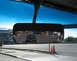 1968 Ford Mustang - Reflection in the rearview mirror shows a black coupe driving on a street with buildings and trees visible.