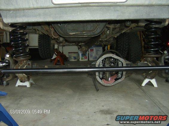Undercarriage view of a vehicle with front axle disassembled, showing new springs and sway bar. Date stamp 03/01/2009
