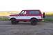 1995 Ford Bronco - This two-tone Ford Bronco is shown from the side with a spare tire mounted on the back.