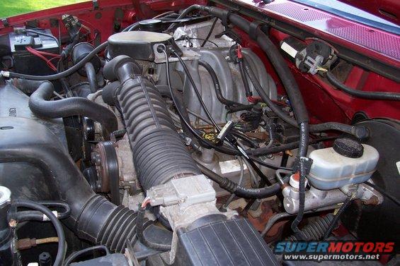 Engine bay with red exterior paint and visible engine components