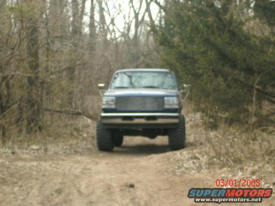Blue 1996 Ford Bronco front view on dirt road