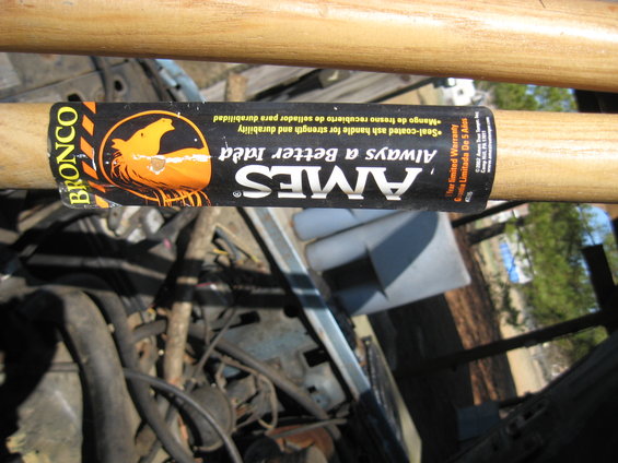 Engine compartment with AMES Bronco label on a tool handle