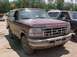 1993 Ford Bronco - This maroon Ford Bronco features a distinctive grille and hood lettering, though its year may differ from registry claims.
