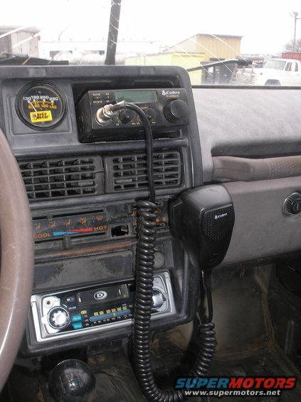 1987 Suzuki Samurai interior dashboard with Cobra CB radio, aftermarket stereo, and gauge