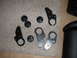 1990 Ford Bronco - Various vehicle parts, including knobs and metal brackets, are displayed on a carpet.